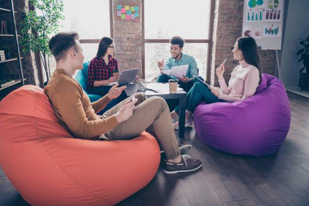 istock Profile side view of nice attractive smart clever intelligent professional interns executive managers analysing data sitting on bag chair at industrial loft interior workplace workstation 1162712301