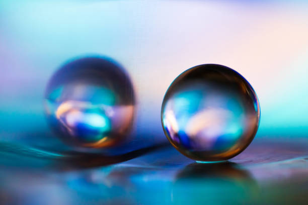 istock Marble on glass plate in blue background. 1162712750
