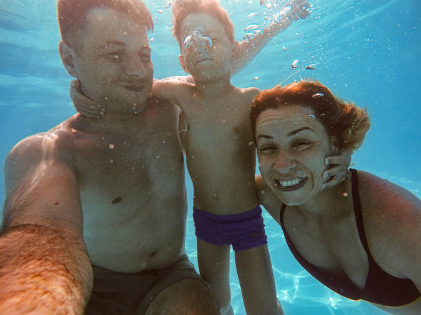 istock Family in the swimming pool 1162713102