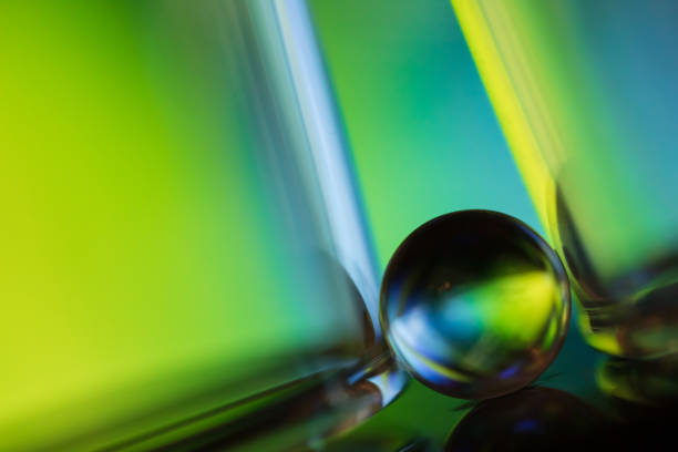 istock Marble on glass plate in green background 1162713245