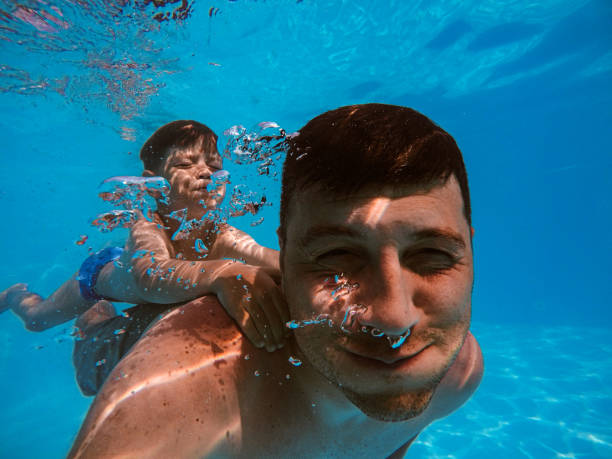 istock Father and son diving 1162713780