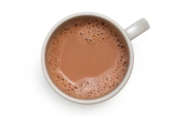 Photo of Hot chocolate in a grey ceramic mug isolated on white from above.
