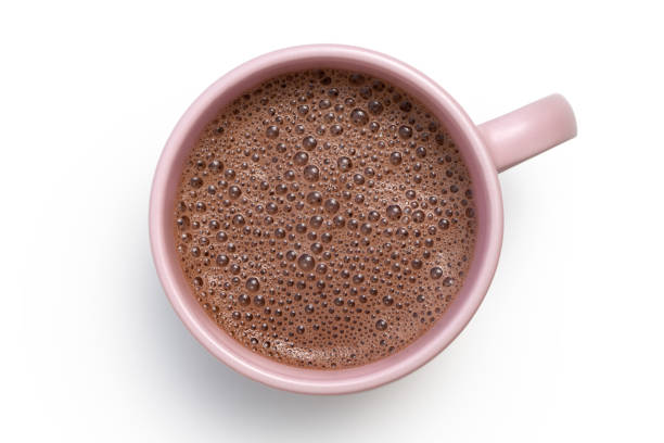 istock Hot chocolate in a pink ceramic mug isolated on white from above. 1162715702