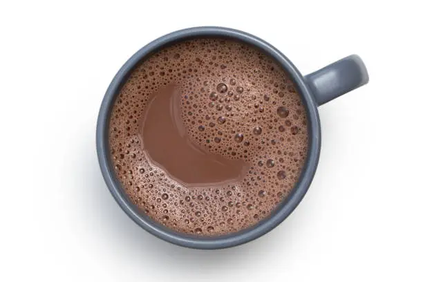 Hot chocolate in a blue-grey ceramic mug isolated on white from above.