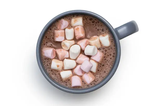 Hot chocolate with small pink and white marshmallows in a blue-grey ceramic mug isolated on white from above.