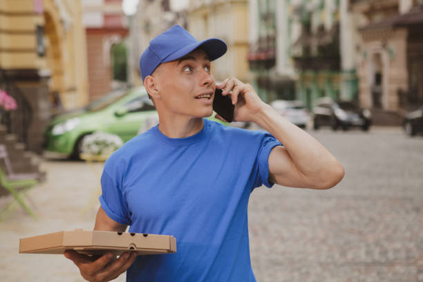 istock Handsome young deliveryman working in the city 1162718169