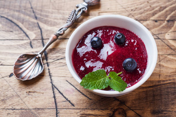 istock Blueberry jam in a plate and fresh blueberries on a wooden table. 1162720382
