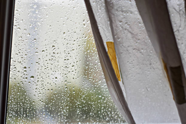 istock Rain drops on window glass background at rainy day blurred outside sky cloud blue texture - Image 1162721717