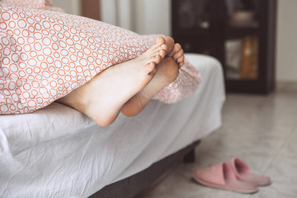 istock Feet girls under a blanket 1162723648