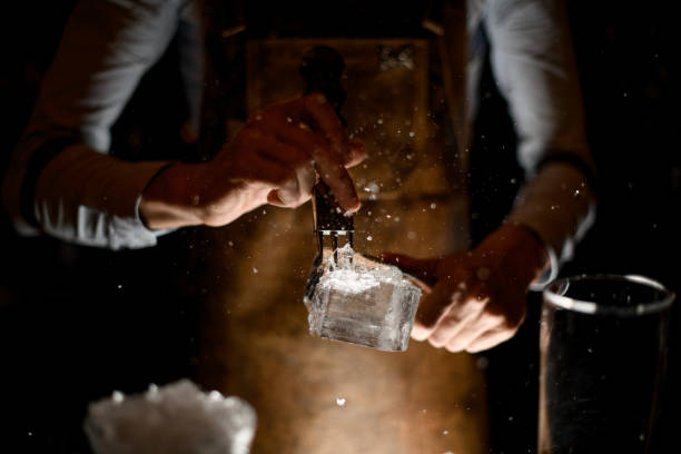 istock Male bartender in leather apron making a crushed with a special instrument 1162725049