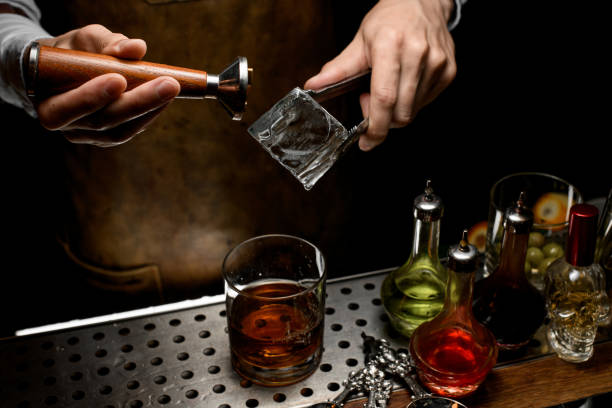 istock Male bartender making a stamp imprint on the big ice cube 1162725099
