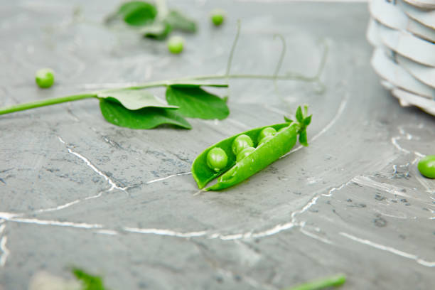 istock White Basket with fresh green peas on grey background. 1162725683