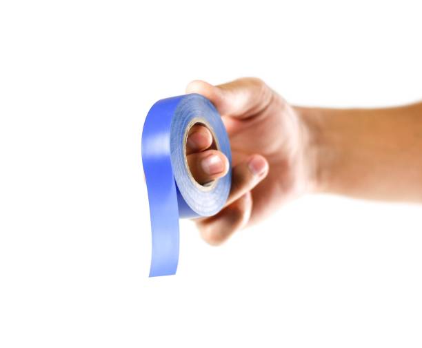 istock Hand holding blue insulation tape. Close up. Isolated on white background 1162726223