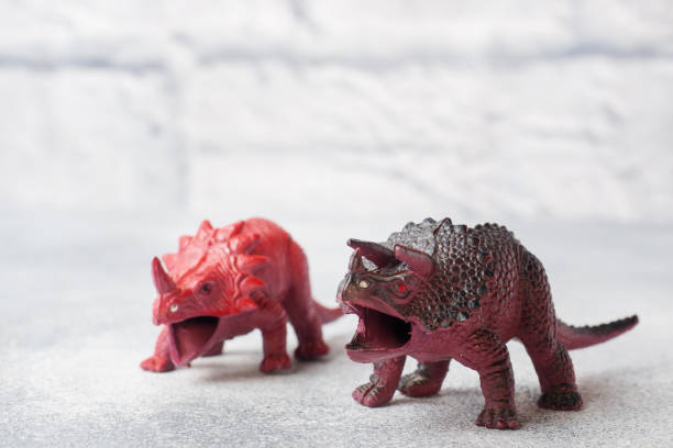 istock Dinosaur on a gray background. Plastic rubber toy. Selective focus. 1162726235