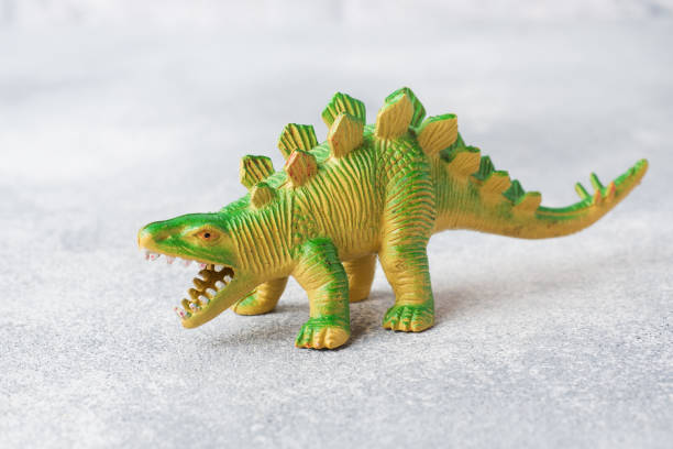 istock Dinosaur on a gray background. Plastic rubber toy. Selective focus. 1162726236