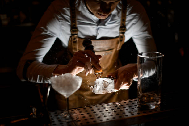 istock Professional male bartender in leather apron making a crushed with a special instrument 1162726758