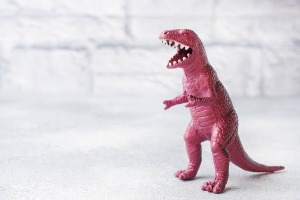 istock Dinosaur on a gray background. Plastic rubber toy. Selective focus. 1162727544