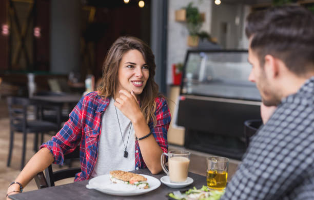 istock Happy loving couple enjoying breakfast in a cafe 1162729108