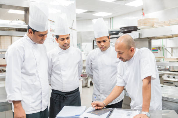 istock Head Chef holding a meeting at the Kitchen 1162730632