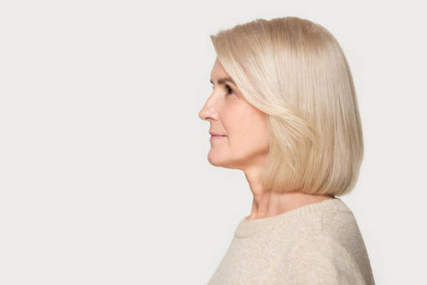 istock Mature woman profile view studio portrait isolated on gray background 1162730984