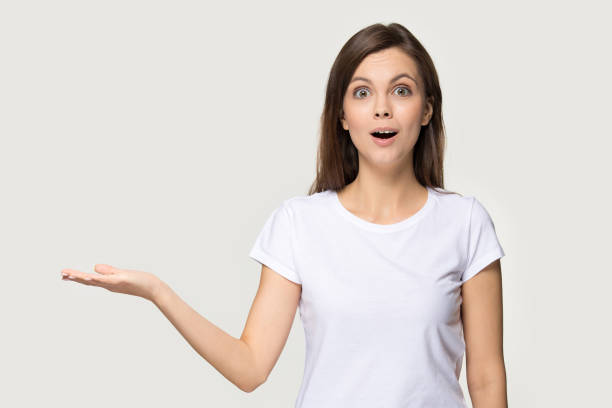 istock Excited millennial woman shocked holding her hand for copyspace 1162731092