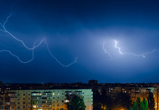 istock Thunderstorm with lightning and thunder over the night city 1162731176
