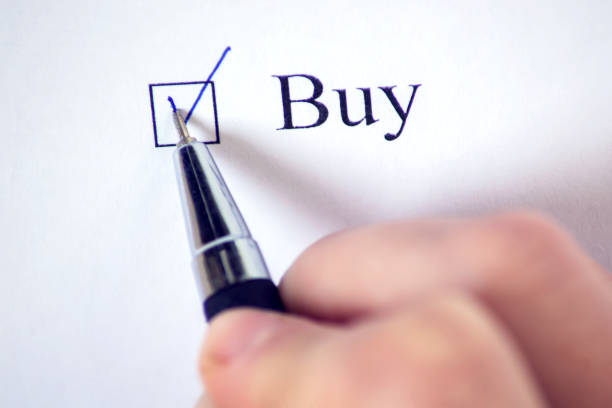 Checklist with a word Buy on white paper with pen. Checkbox concept.