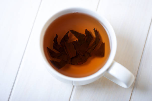 istock Halloween spider make from tea leaves into tea cup on white wooden table. Halloween celebration concept. Copy space 1162735929