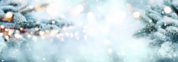 Cold blue snowy winter scenery with bright bokeh for a christmas decoration