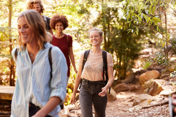 istock Smiling millennial girlfriends walking together during a hike in a forest, close up 1162738039