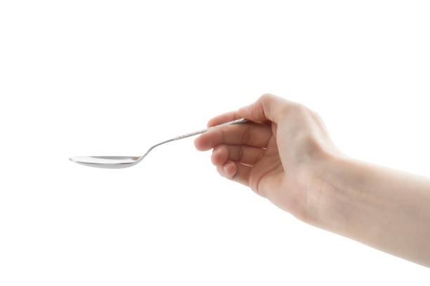 istock Female Hand Holding Spoon 1162740162