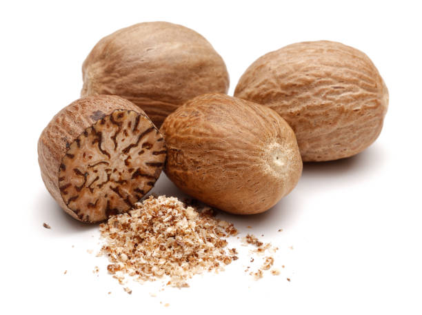 istock Whole and grated nutmeg isolated on white 1162750560