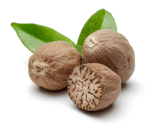 istock Whole and half nutmeg with leaves isolated 1162752273