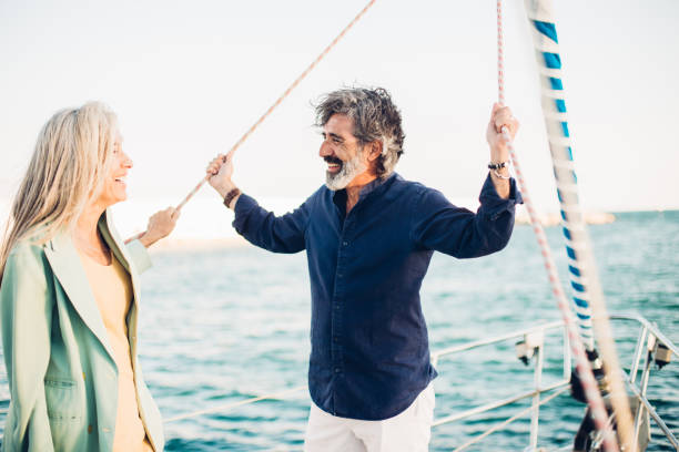 istock Old man and woman standing on a boat 1162755656