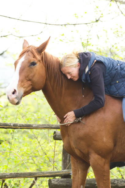 istock Relaxed and Happy Young Woman Hugging her Horse while Sitting on it´s Back 1162756087