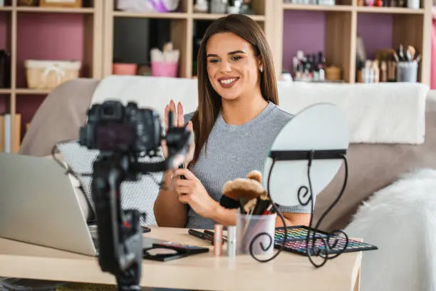 Photo of Vlogger creating beauty video podcast at home