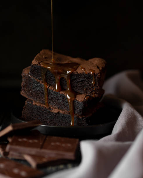 istock Pile of brownie poured over with topping 1162756449