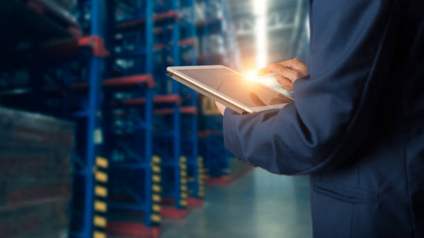 istock Businessman manager using tablet check and control for workers with Modern Trade warehouse global business commerce concept or import-export commercial logistic. 1162758680