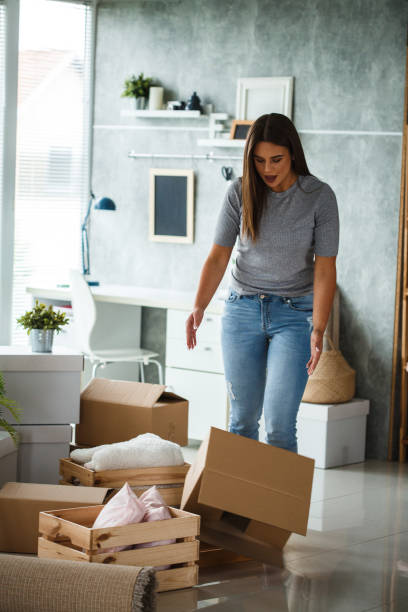 istock Clumsy woman dropping moving box 1162759487