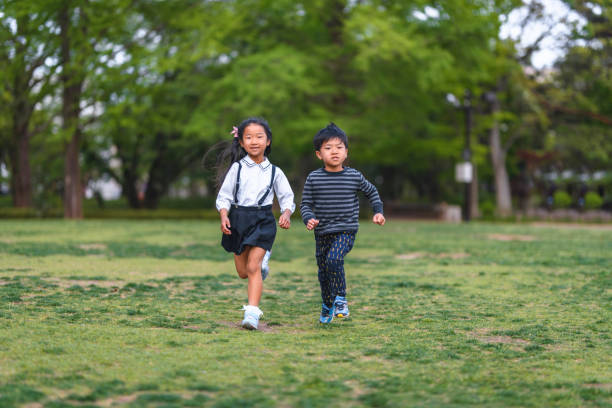 istock Energetic Japanese Schoolchildren Running at Public Park 1162761252