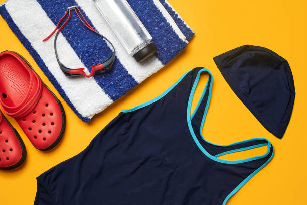 istock Flat lay summer pool accessories on a yellow background. Colorful beach wear 1162761315