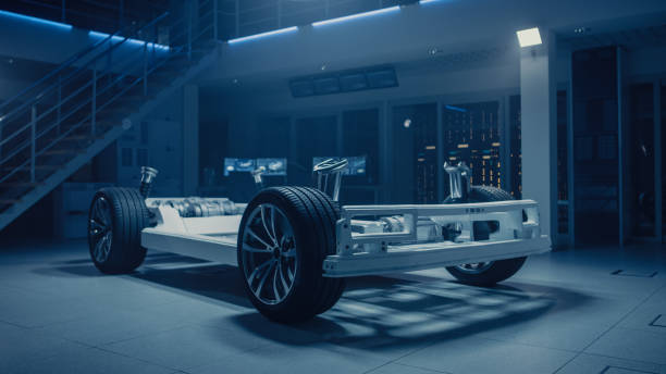 istock Concept of Authentic Electric Car Platform Chassis Prototype Standing in Industrial Machinery Design Laboratory. Hybrid Axel Frame include Wheels, Suspension, Engine, Brakes and Battery. 1162762081