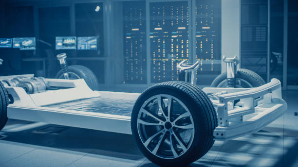istock Automobile Engineers Discussing and Designing Electric Car Chassis Platform, Using Tablet Computers with 3D CAD Software. In Automotive Innovation Facility Vehicle Frame with Wheels, Engine and Battery 1162762153