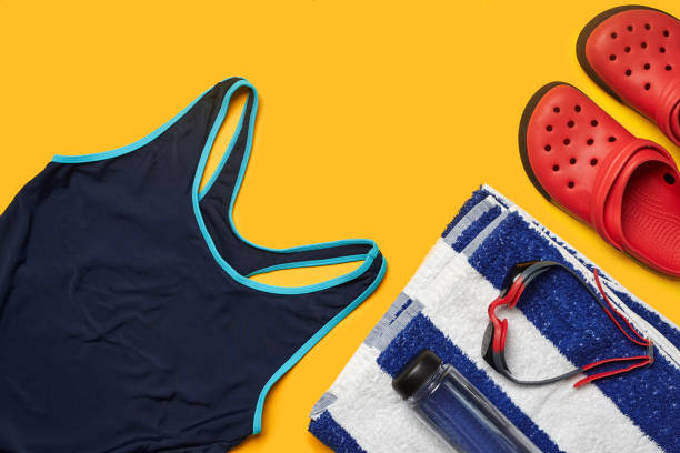 istock Flat lay summer pool accessories on a yellow background. Colorful beach wear 1162762483