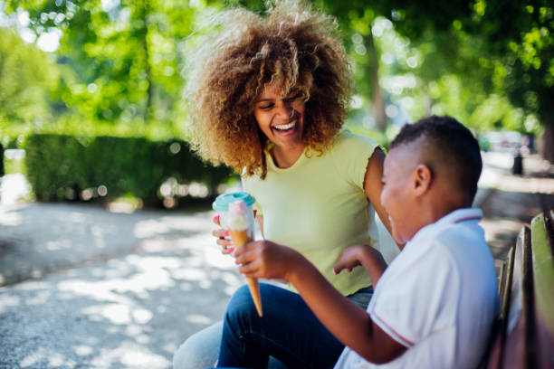istock Happy woman having ice cream with son 1162763065