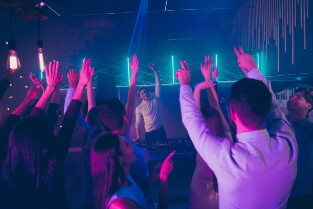 istock Back rear photo of cheerful fellows students listen dj playing mixer consoler panel disc hockey make v-signs dancing floor discotheque 1162766224