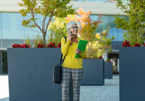 istock Businesswoman using mobile phone outside office 1162770830