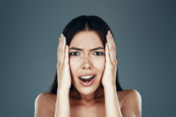 istock What? Surprised young Asian woman looking at camera and making a face while standing against grey background 1162773666