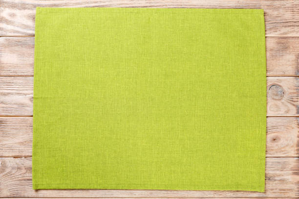 istock green cloth napkin on brown rustic wooden background top view with copy space 1162773959