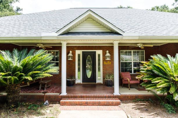 istock Black Front door of Traditional red brick home 1162774783